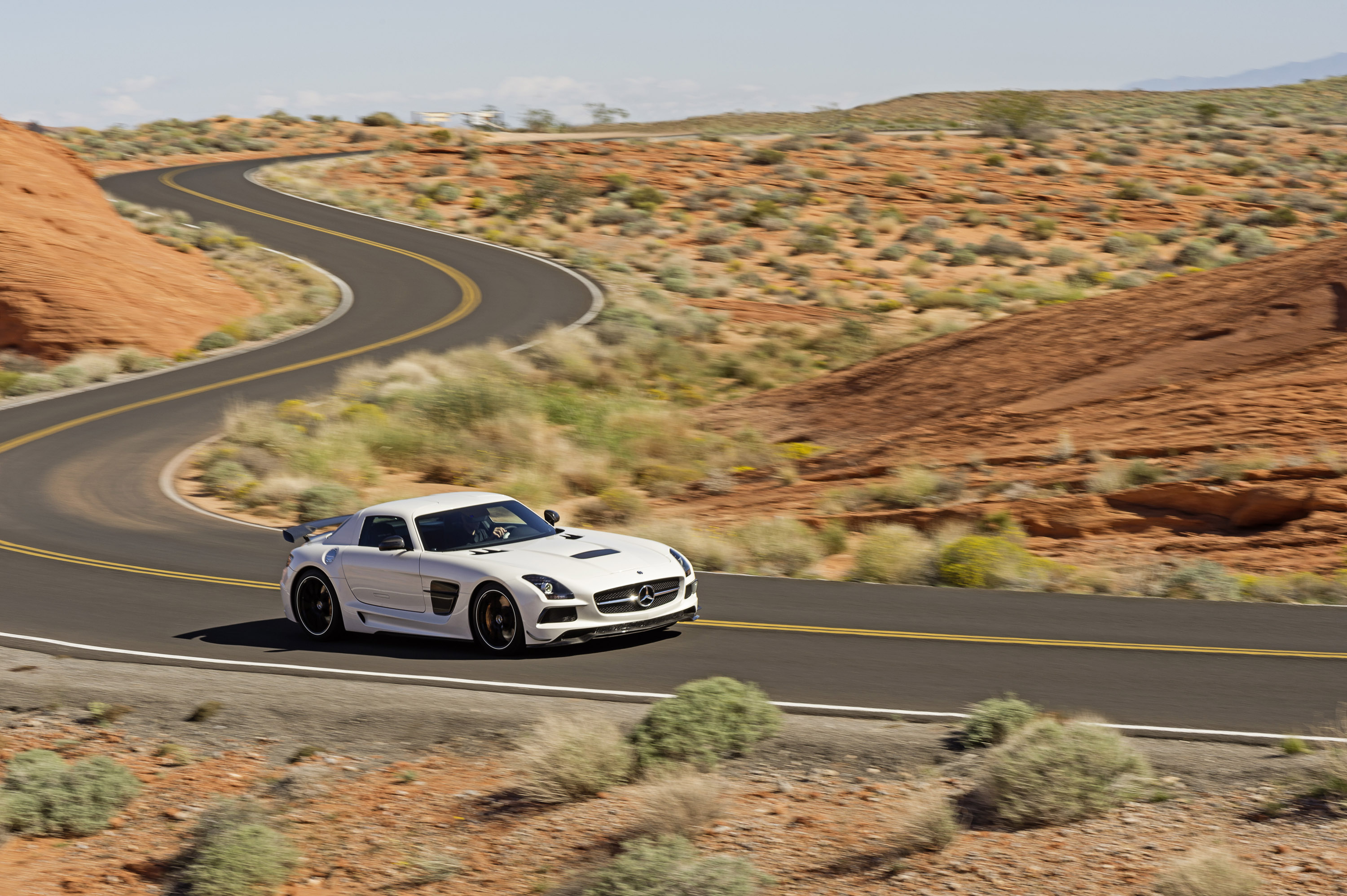 Машина едет по прямой дороге. Mercedes SLS AMG White. Mercedes SLS AMG Black Series. 2010 Mercedes Benz SLS AMG Desert. White SLS AMG Coupe.